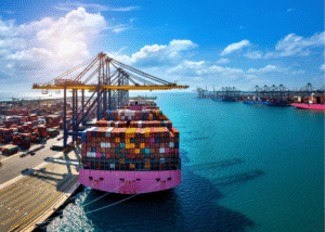 IEEPA Tariff Termination Shipping containers stacked at an international cargo port with cranes and vessels in the background, representing global trade and customs operations.